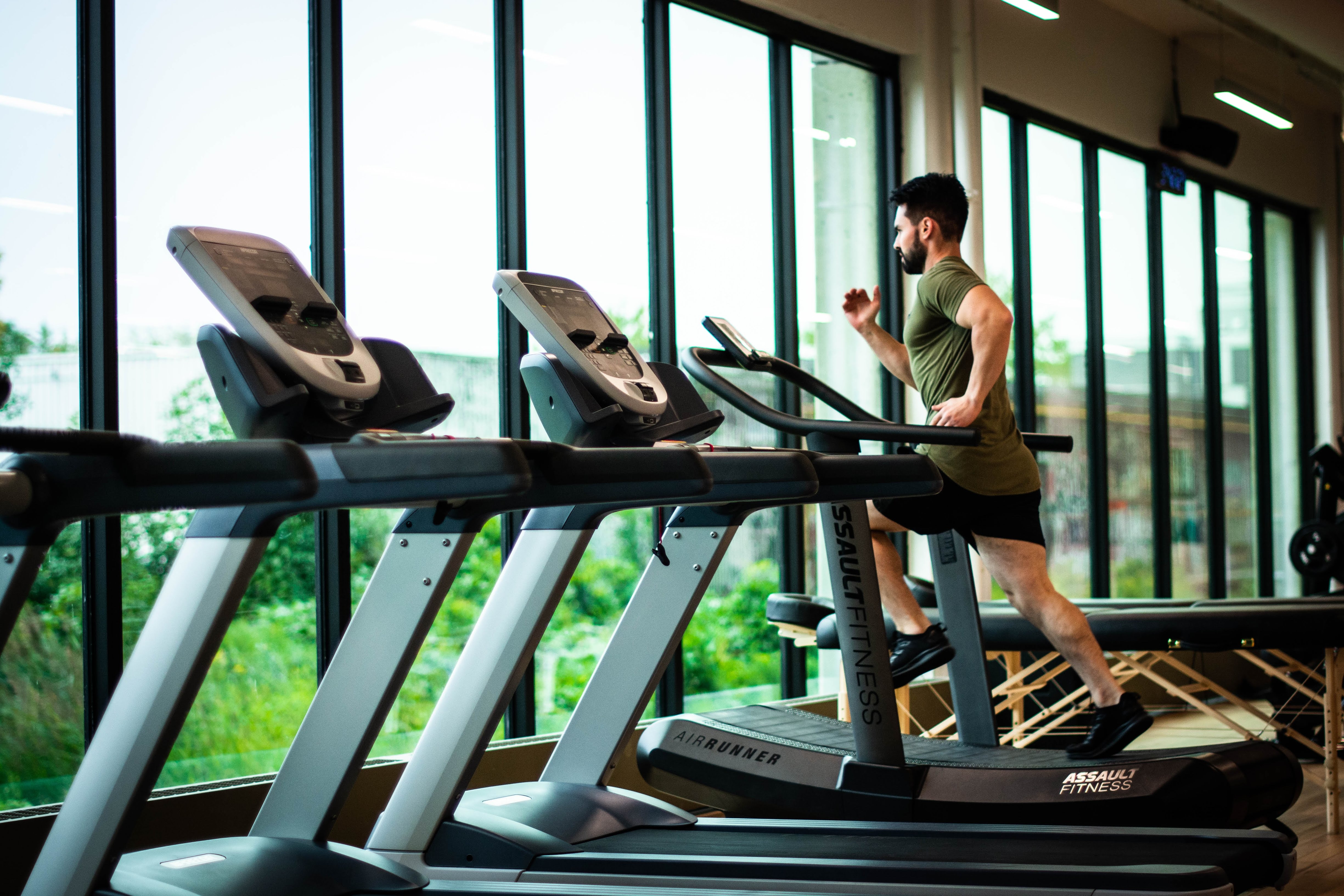 Photo of one of the members doing a HIT workouton a treadmill.